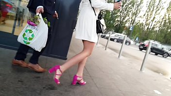 Play Beautiful woman on high pink high heels and a short dress on shopping. He picks up the dress